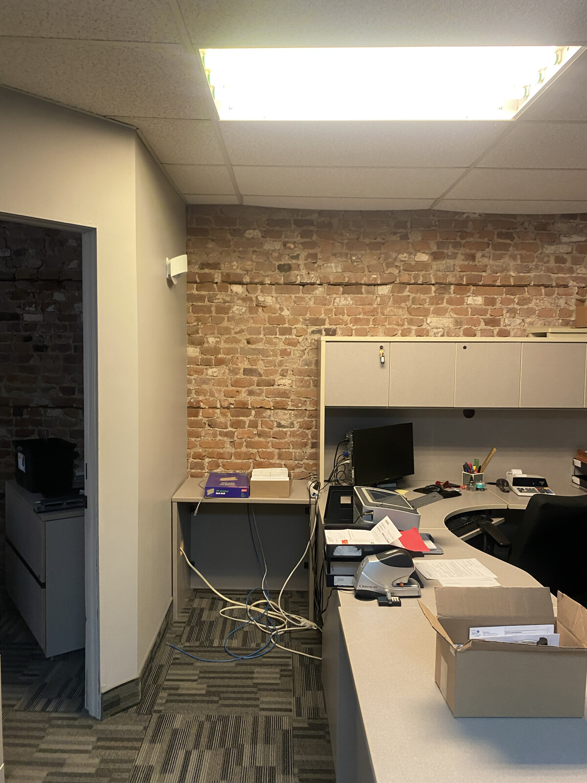 BEFORE: The brick was a hint this office space had good bones... if you could tear your eyes away from the fluorescent ceiling light.