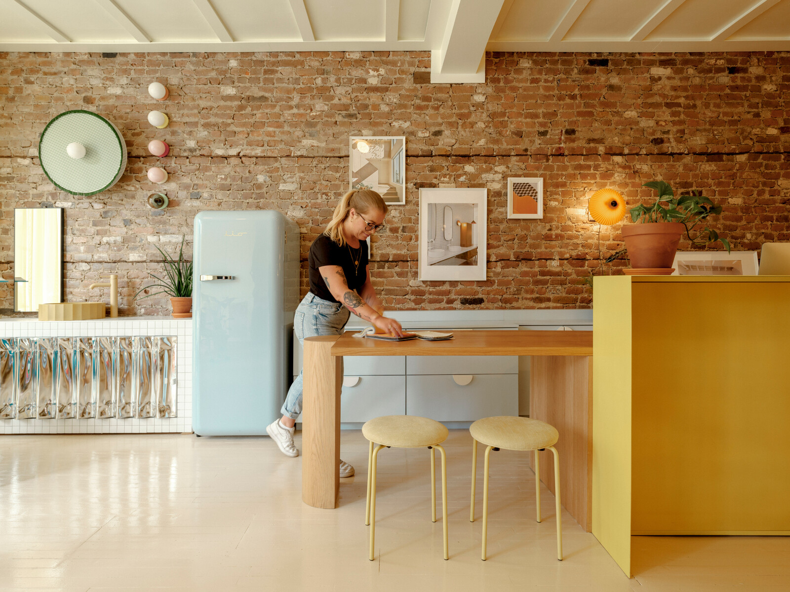 Stools are by Hubush Interior and the lighting behind the desk is from Hay. 