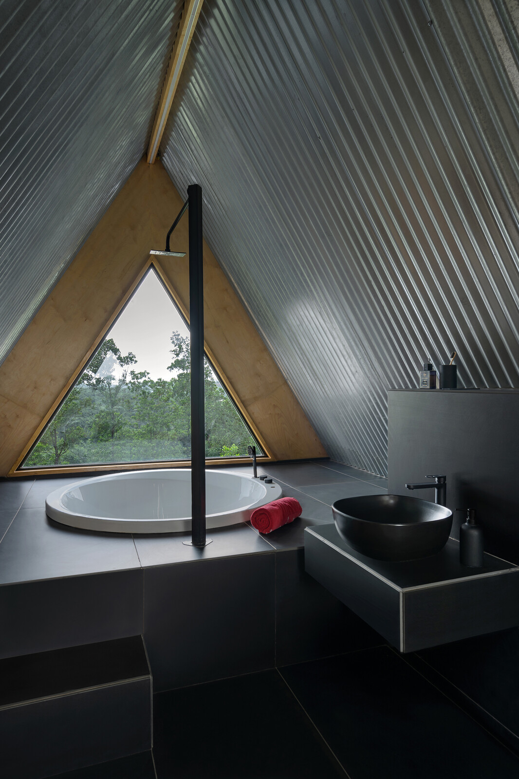The bathtub has the best views in the whole house, tucked by the window in the loft underneath the A-frame roof. 