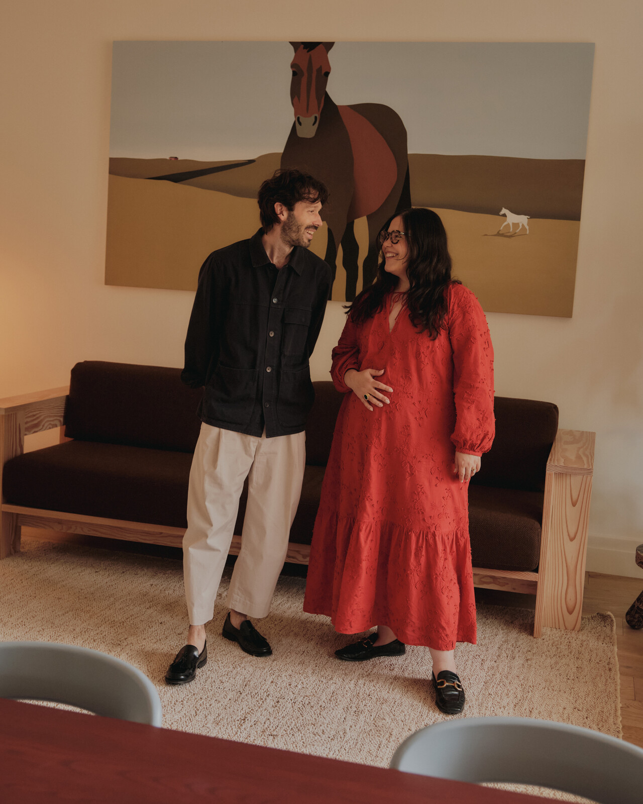 Principals Justin Lortie and Sarah Di Domenico, pictured in the living room of the office-house. Behind them is a painting commissioned from friend Dan Climan.