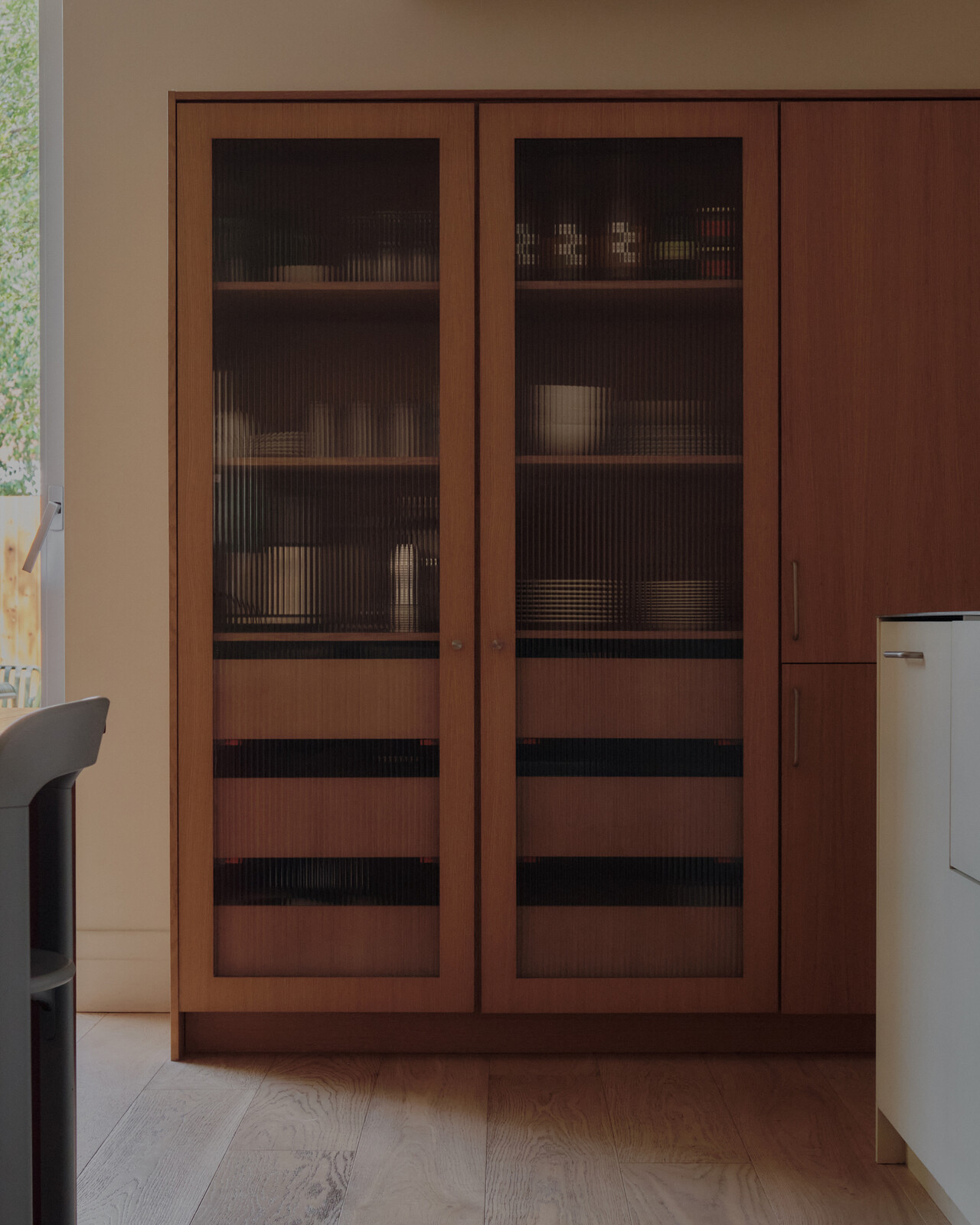 A custom storage cabinet holds dishware for team meals. The first floor is a functional office day-to-day, but Wedge also likes to lend it out for community events like book launches, workshops and pop-ups. 
