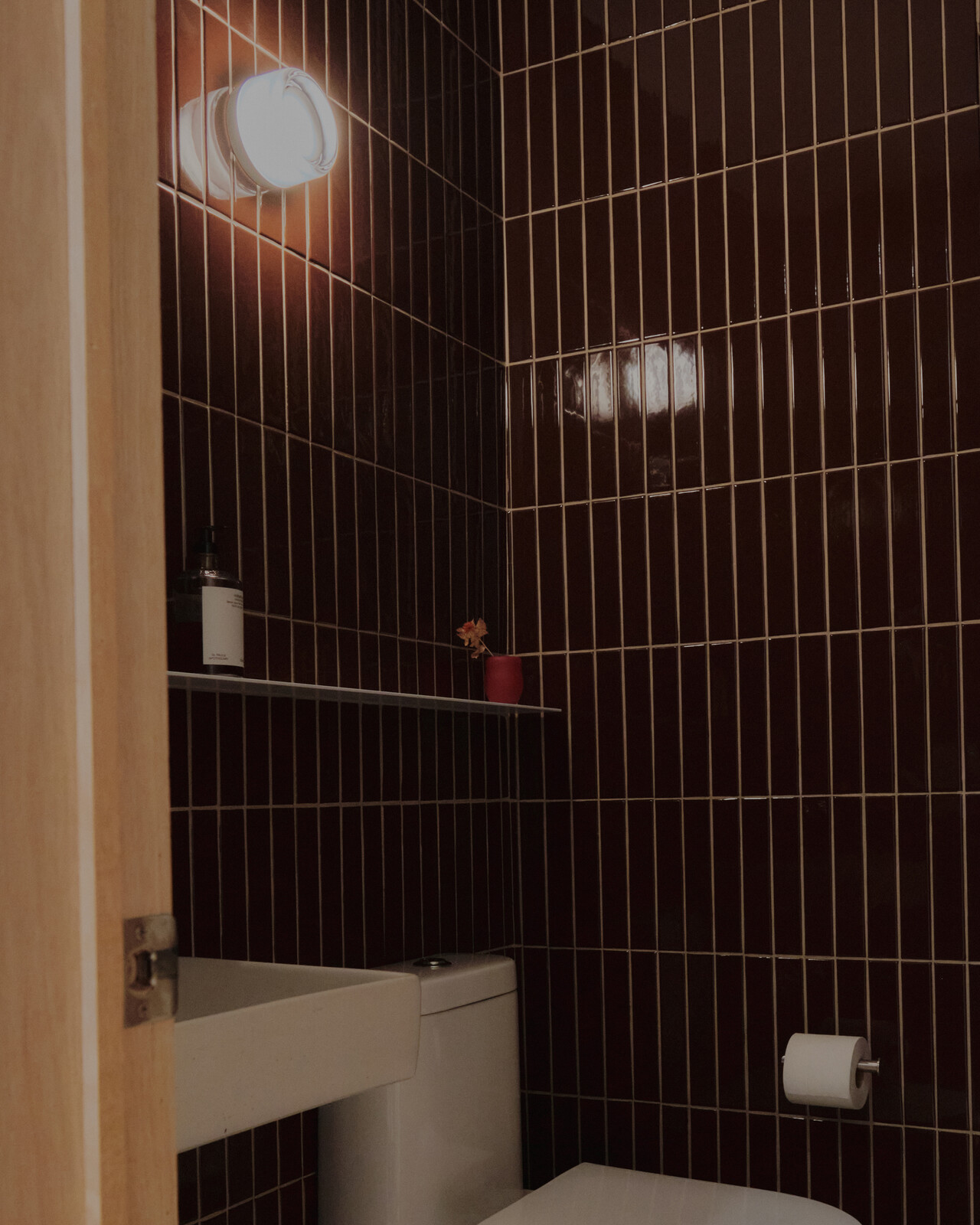 The rest of the space is light, soft and bright, but the bathrooms are dark and intimate. 