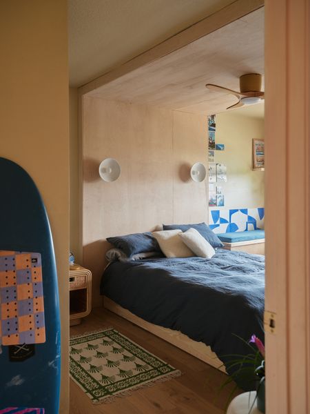 Will's custom capsule bed, inspired by The Public hotel in NYC, creates a cozy sleeping nook wrapped in warm plywood that feels both modern and surf-shack casual.