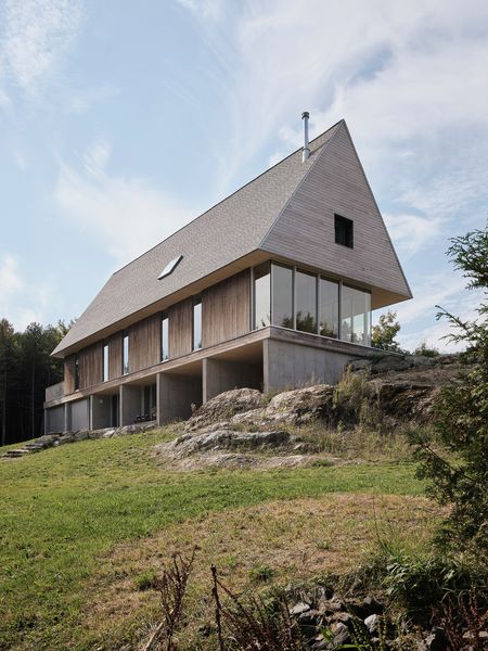 The simple gabled form echoes traditional barns in this rural Quebec region, with natural eastern cedar cladding that will develop a gray patina over time.