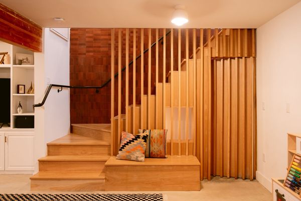 Thick wood slats and thinner metal slats create a collaged guardrail system.