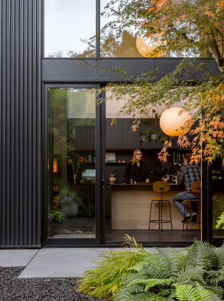 Leftover Madera oak flooring wraps the kitchen island face. Caesarstone quartz appears only at sink locations to control costs.