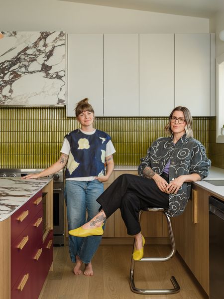 Xenia Rose (left) and Kate Dubois balanced bold color with white and wood for this home renovation and expansion in Ontario.