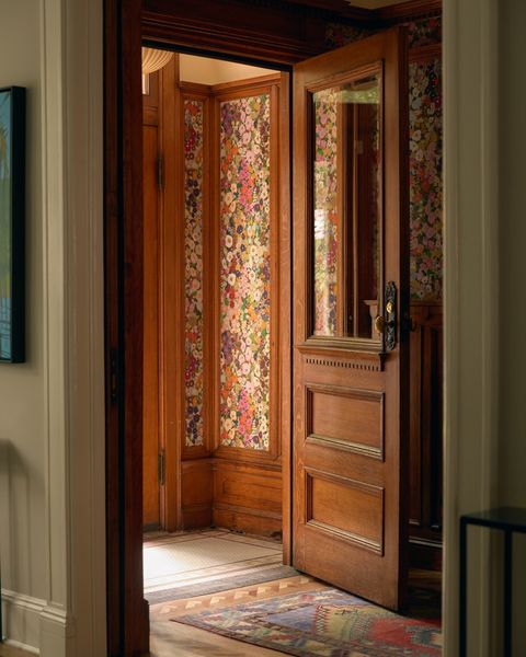 Set against the warmth of original wood moldings, floral wallpaper sets the tone for the interiors. 