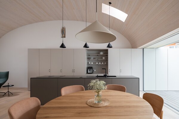 In the idyllic Czech town of Trhové Sviny, an imaginative architect couple created one cohesive family home by joining and renovating two adjacent dwellings. The spruce-clad ceilings and calming, muted tones of the kitchen are softly integrated with the home’s original historic fabric.