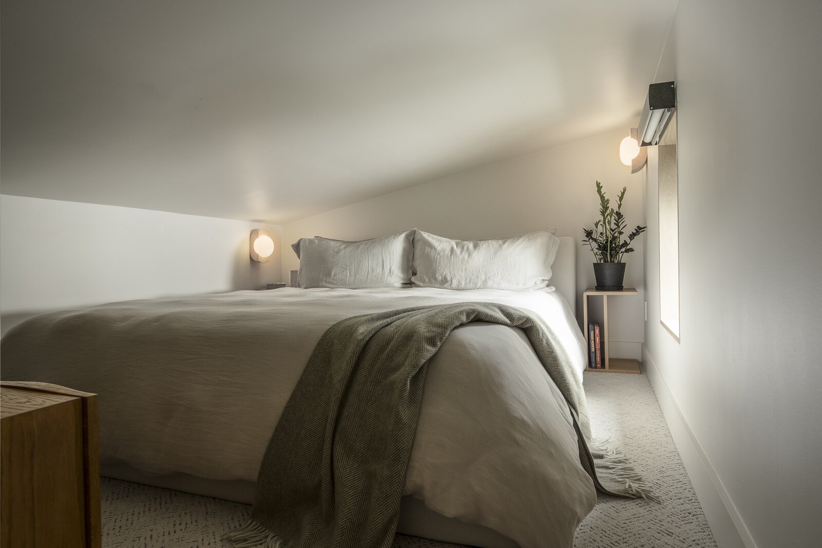 The upstairs sleeping loft is used by the couple's family and friends that frequently come to visit. It’s furnished with the Ophelia Bed purchased from Rove Concepts.