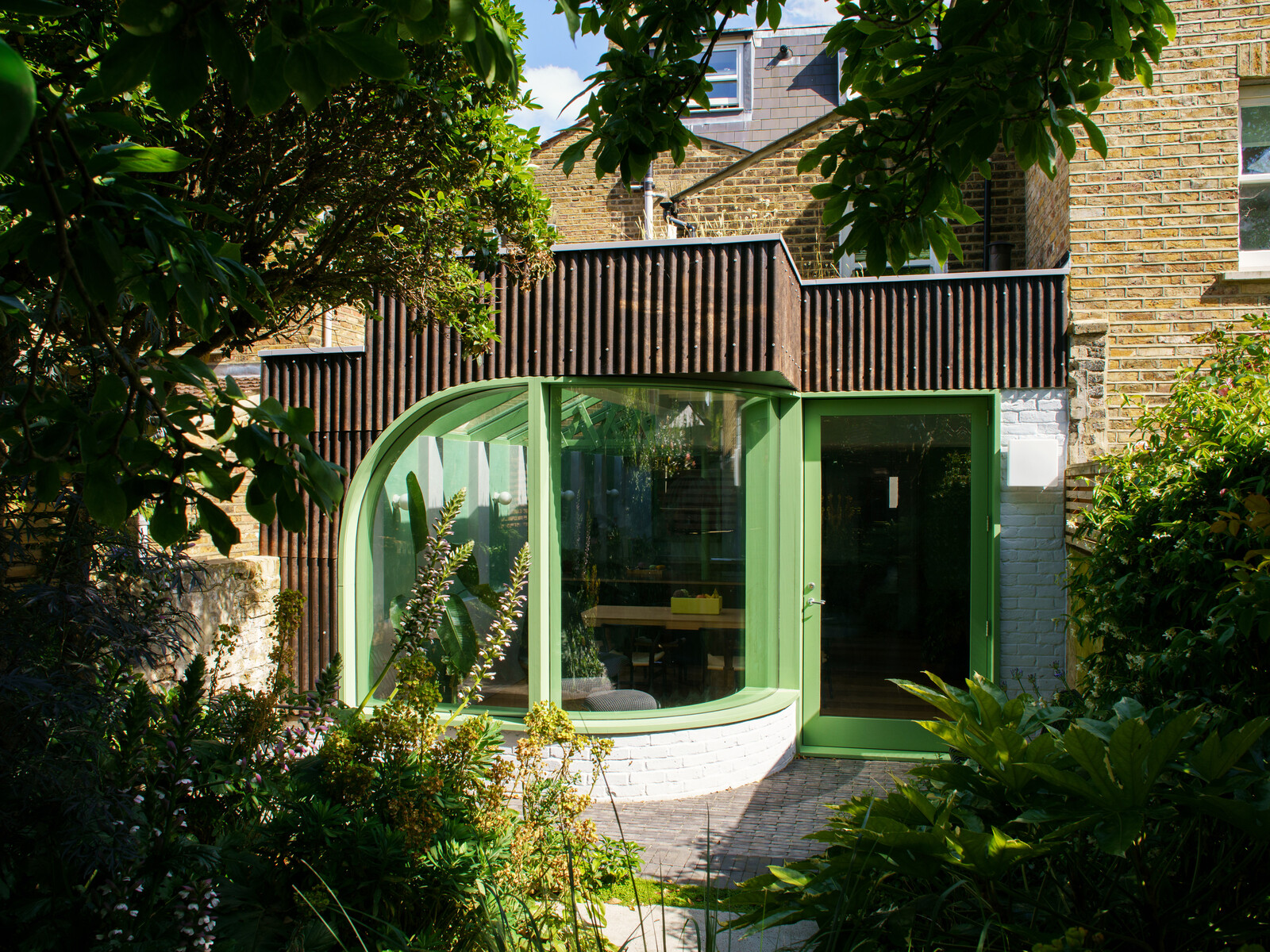 This London renovation by CAN features corrugated cladding crafted from hemp fiber panelling. The innovative—and highly sustainable—materials will change color and texture over time, just like the Cor-Ten steel it mimics.