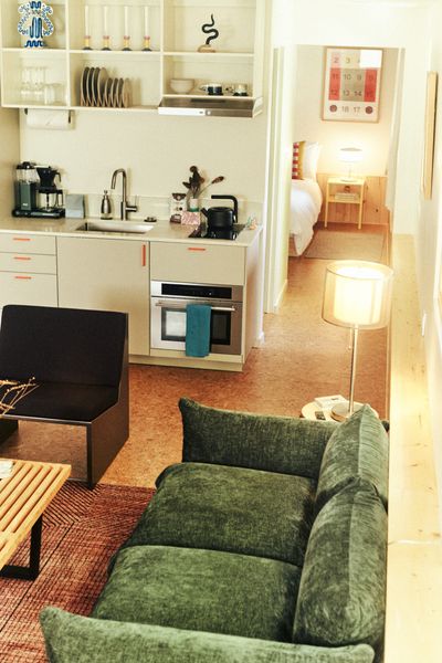 The kitchen cabinetry is from Ikea. It features orange handles found via Etsy.