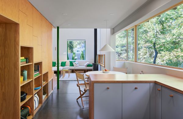 Marine grade plywood forms the built-in storage spaces, adding a layer of warmth and texture to the restrained interior.