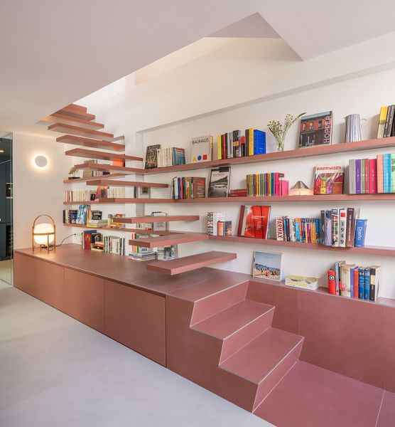 Philippe has an impressive collection of books, but prior to the renovation they were scattered all over. The integrated shelves lining the staircase consolidate his books and create a hybrid stair-storage-shelving system.