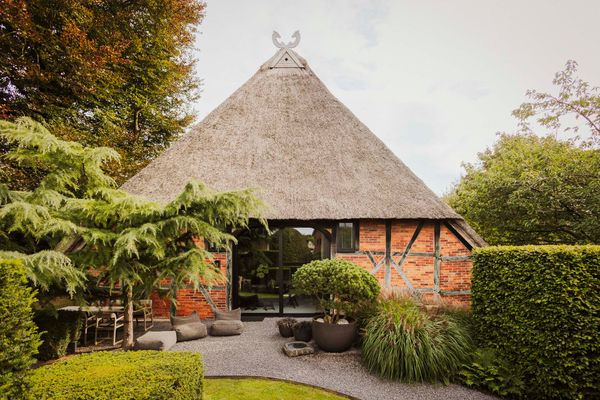 The exterior of this historic thatched roof cottage has been carefully preserved, while the interior has been recently renovated.