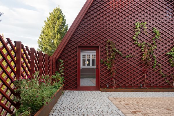 A family added two larger structures and two gardens—one outdoors, and another enclosed with glass looking out onto the forest.
