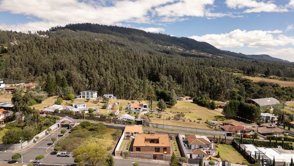 This hillside residence, built for a retired couple, circles a courtyard in a continuous loop.