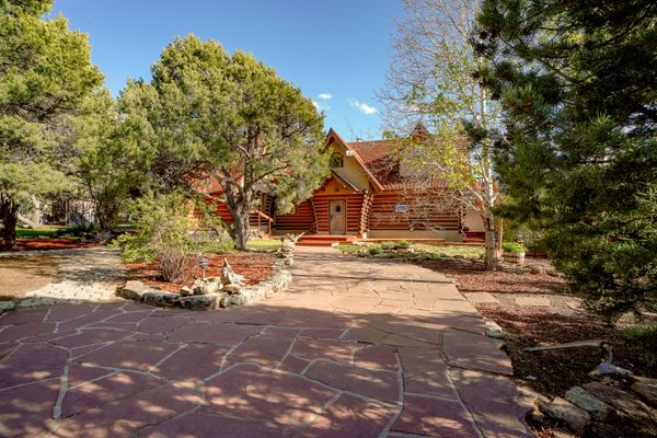 This chinked-log cabin home is located near Carson National Forest in New Mexico.