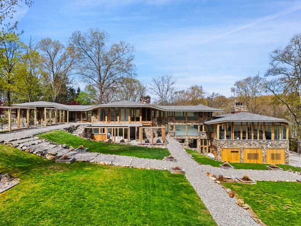 Spanning nearly six acres, the contemporary estate includes a main house, a pair of guest residences, and a saltwater pool.