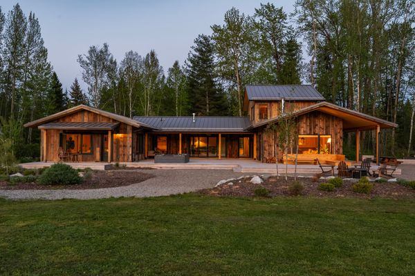 The exterior features reclaimed barn wood siding and a standing seam metal roof.