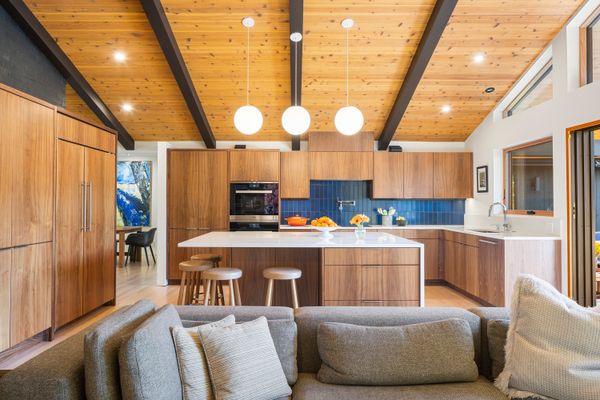 Much of the tile throughout the home is by Heath Ceramics. The custom walnut and oak cabinetry is by Artisan Woodworking.