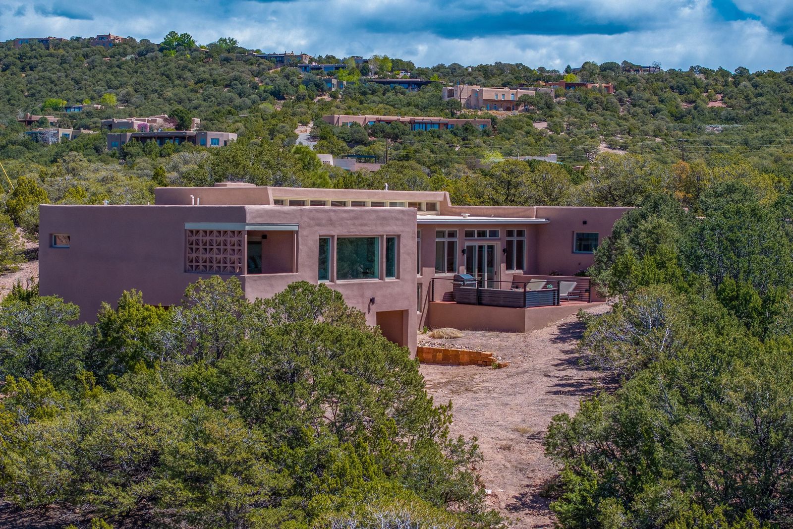 This sprawling home in Santa Fe is located on an elevated lot with sweeping views of the surrounding landscape and nearby mountains.