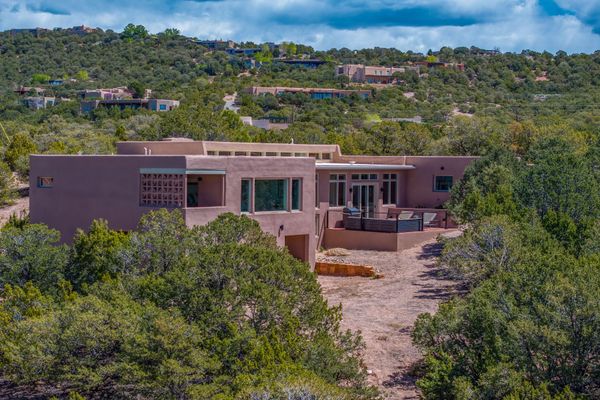 This sprawling home in Santa Fe is located on an elevated lot with sweeping views of the surrounding landscape and nearby mountains.