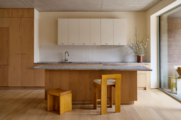 A Nordic chestnut and stone island anchors the kitchen, accented by track lighting.