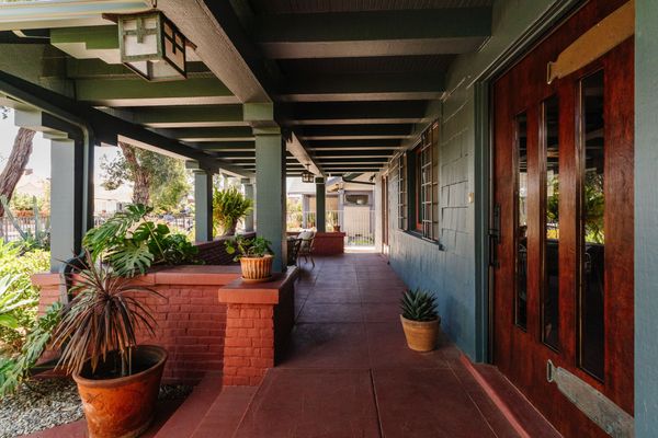 The deep front porch provides welcome shade on sunny days in Los Angeles.