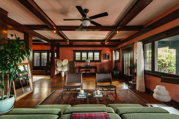 The formal living and dining rooms are anchored by thick wood columns.