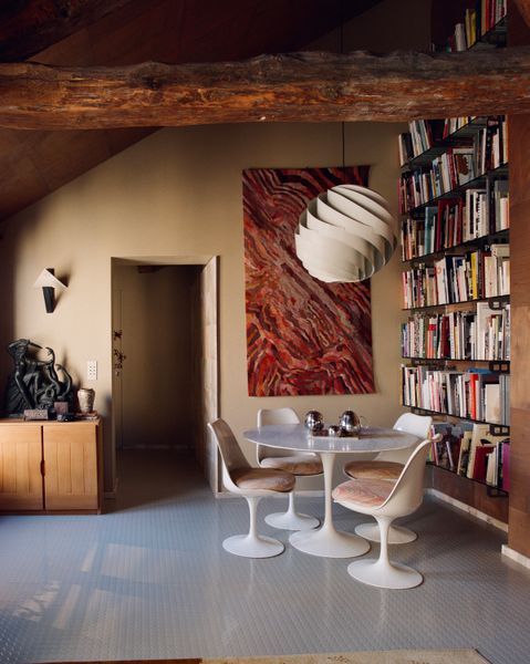 Architect Jules Brisson brought in okoumé wood panels, tiles from Portugal, and a trove of vintage furniture for this flat in Le Marais.