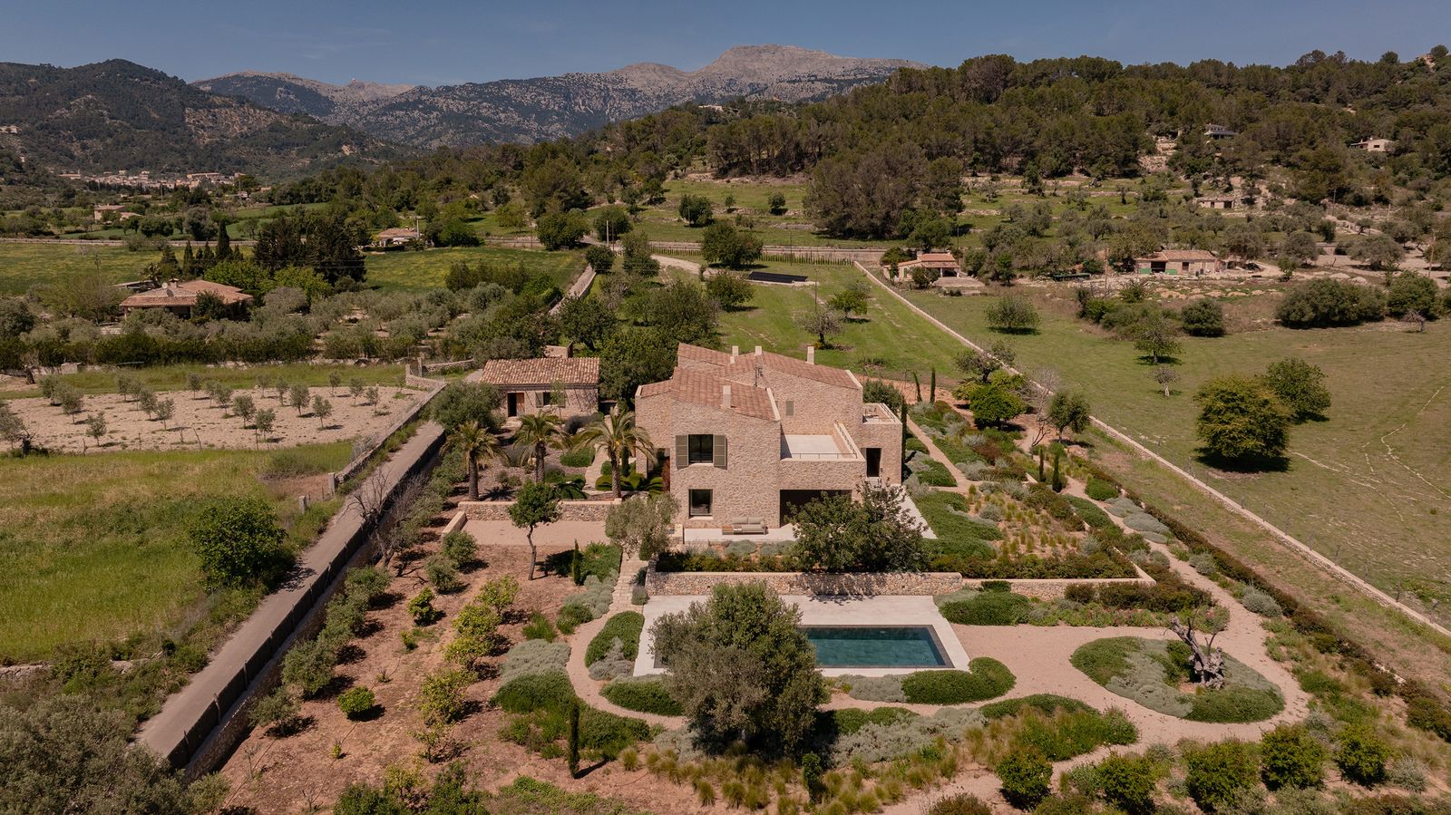 The grounds feature a saltwater pool, multiple landscaped gardens, and various private terraces.