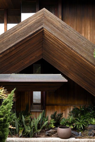One of the most striking features is the stacked wood fascia that traces the home's roofline.
