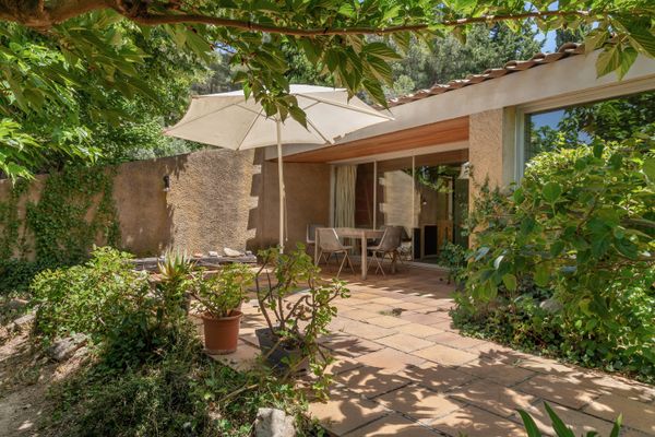 The exterior's ochre-coated concrete, typical of the time, is completed by swathes of glass and Provençal tile.