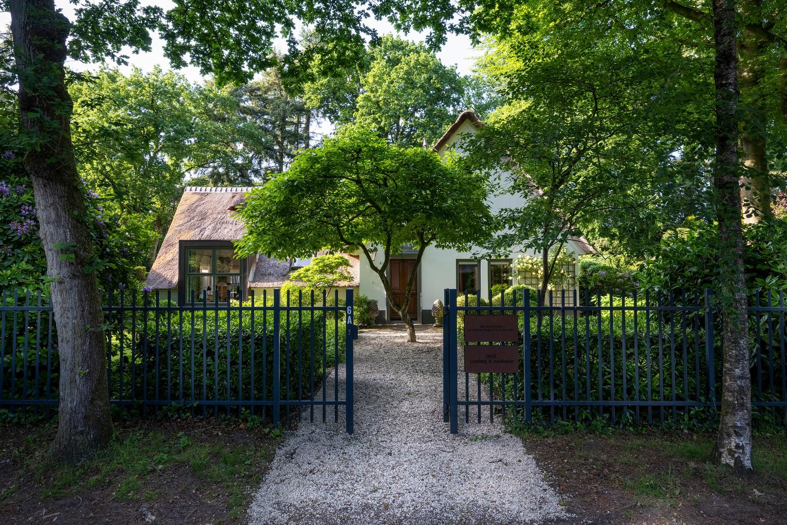 This 1978 home has a thatched roof, a traditional brick facade, and refreshed interiors with terra-cotta tile floors.