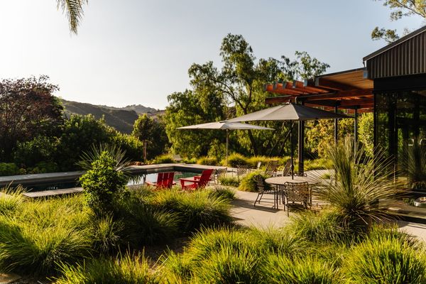 In the backyard, which has been featured in campaigns for Mercedes-Benz and Lexus, a saltwater pool overlooks the property's fruit trees as well as distant canyon views.