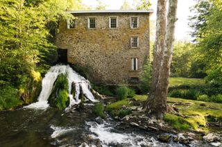 A Waterfall Rushes Through This $5.25M Mill Turned Residence in Upstate New York