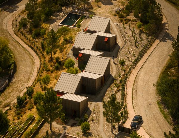 This prefab structure in Paredes, Portugal, is stitched together at the edges to form a long, offset plan.

