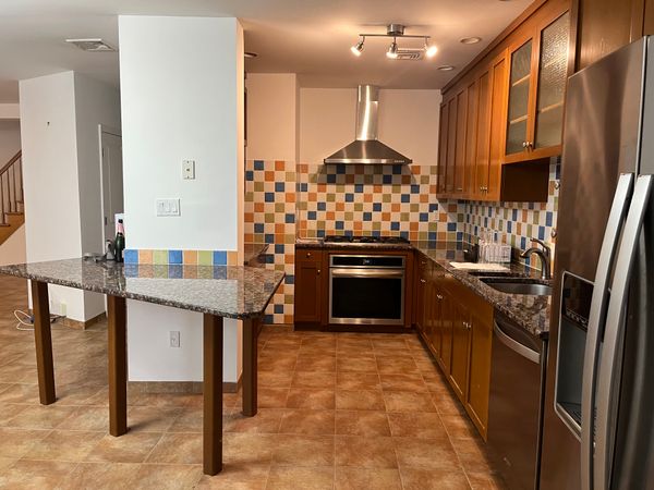 Before: Bulky columns and unnecessary walls created a dark, cramped galley kitchen. The renovation replaced the clumns with much smaller decorative enclosures and tore down the additional walls.
