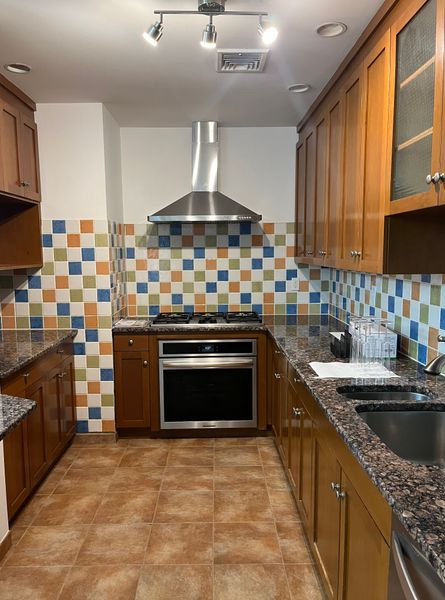 Before: The dated floors, counters, and tiles were all replaced. To cut down on costs, the couple decided to keep all the appliances and refinish the cabinets, rather than replace them entirely.