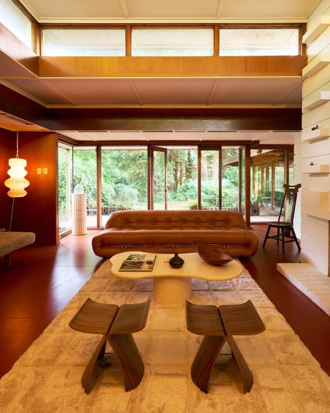Operable floor-to-ceiling glass windows connect to the backyard.