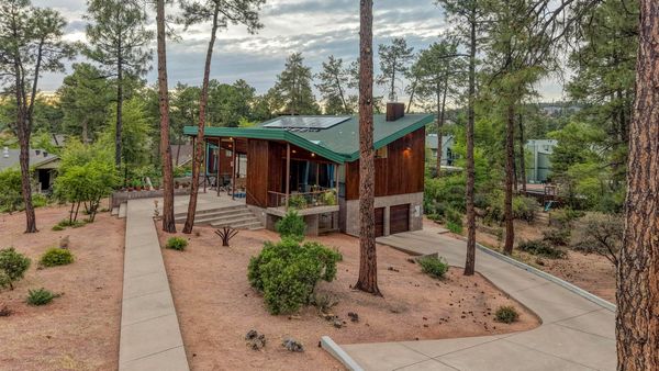 The home is set on a private lot surrounded by mature ponderosa pines.