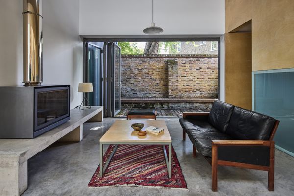 The southeast-facing outdoor space includes a built-in bench and a brick patio.