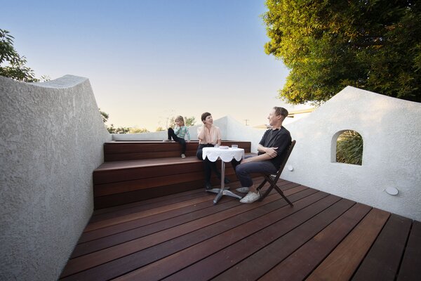Architect Ben Warwas chats with his family on the roof deck. The decking is Mangaris hard wood.