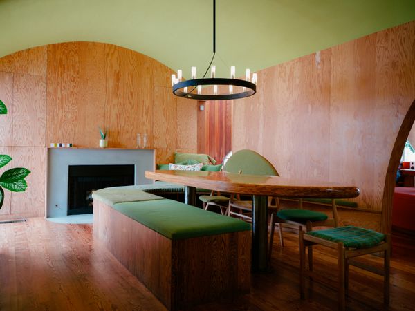 The plywood-lined dining room is a mix of greens. Stephanie and Pete kept the room intact, after considering opening it up to the living room. 