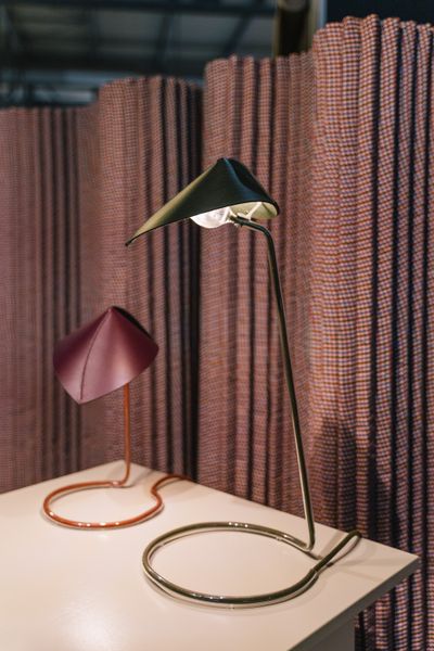 It takes a careful look, but the leather-topped lamps by Luis Marie have bunson-burner style glass surrounding their cords.