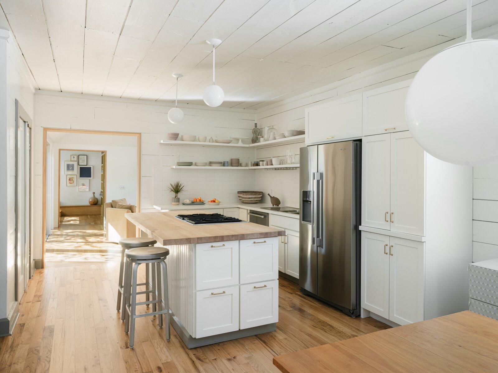 The kitchen remains mostly untouched, but the design team added new cabinetry around the refrigerator. 