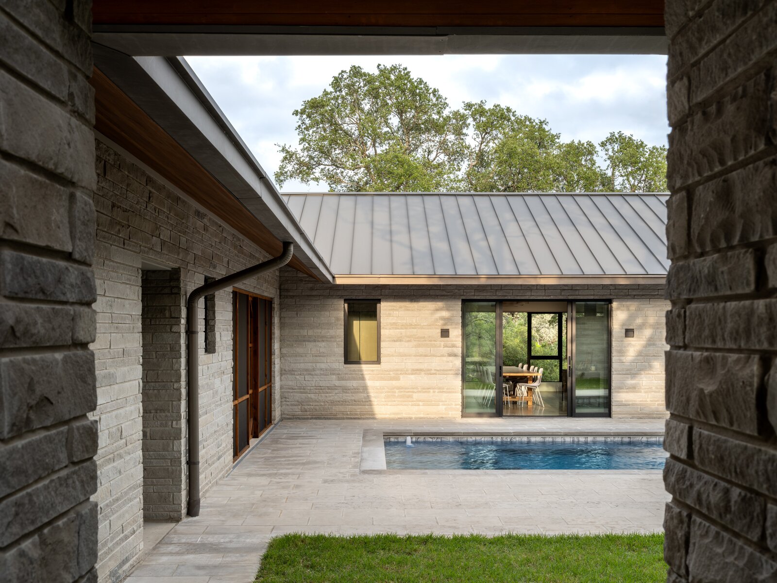 
The house opens to the central courtyard, where the swimming pool is a hit in the summer. The space is lined with Leuder’s limestone. 