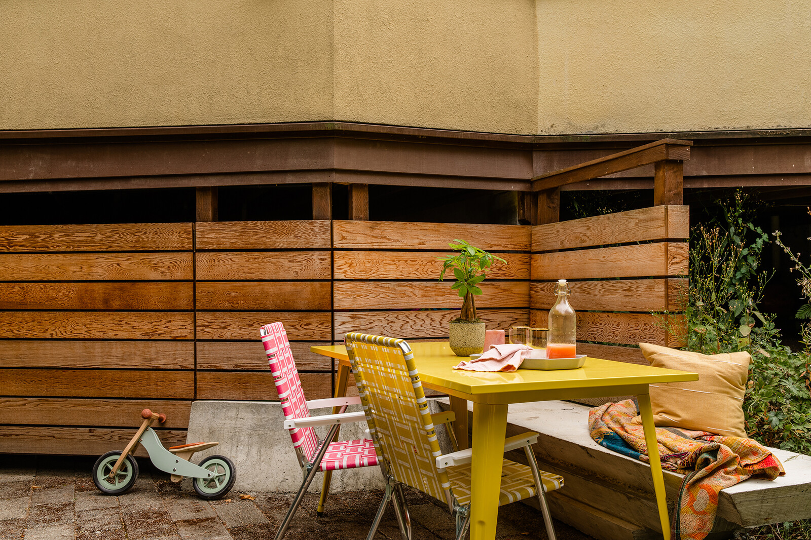 In the summer, friends frequently come over for outdoor meals, and the couple's daughter enjoys scooting around on her balance bike. 