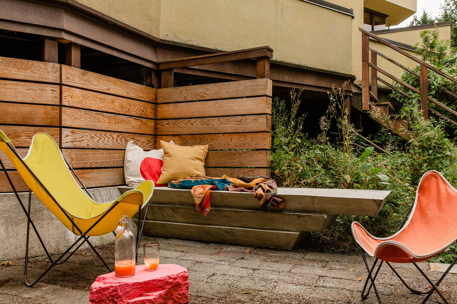 A custom cantilevered bench on the patio is a cozy corner on warm summer days. Due to the way the townhomes are angled, Daniel and Sandy have the largest backyard, but the smallest driveway. 